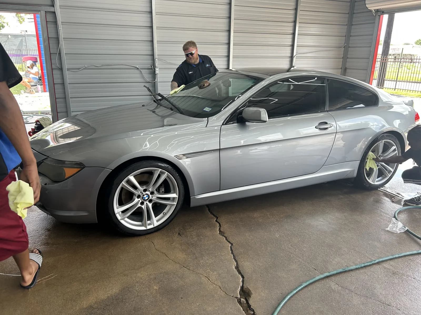 Silver BMW being hand washed in a Faevaa bay