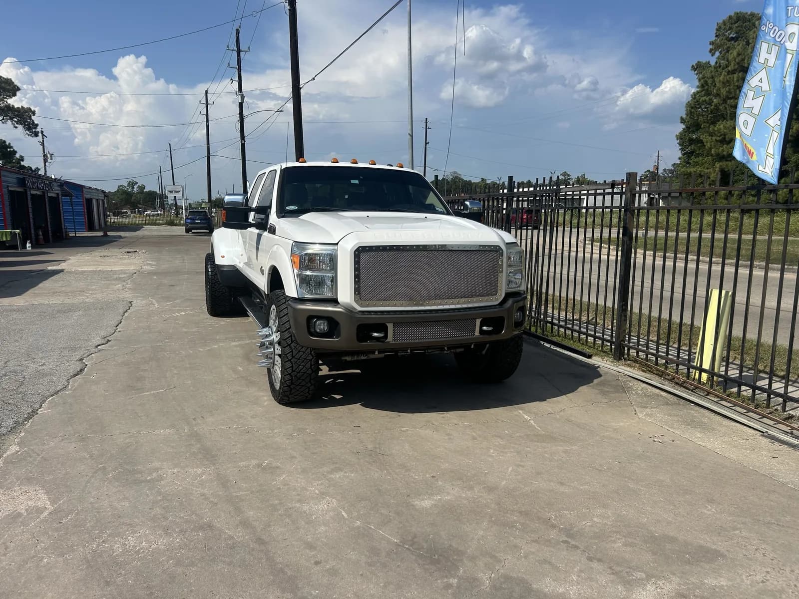 Detailed white dually rolling out past the Faevaa gate