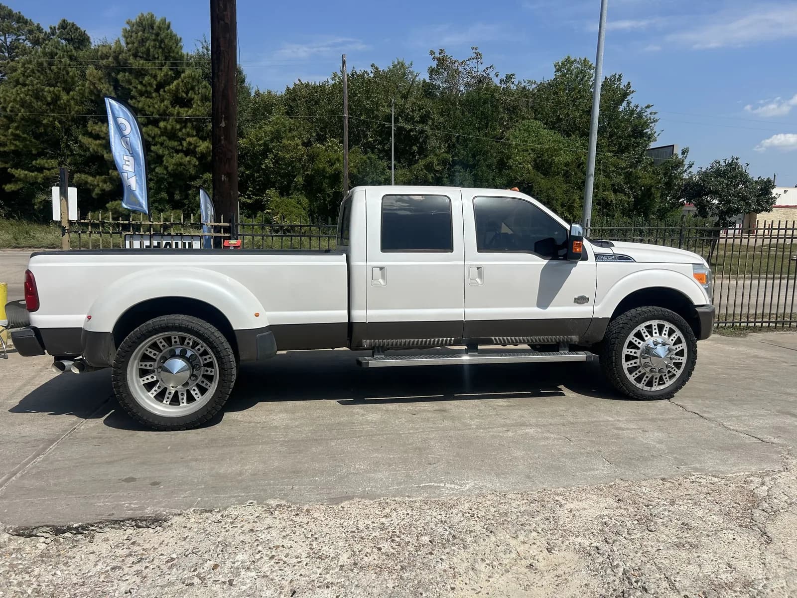 White Ford Super Duty dually on custom wheels, freshly detailed