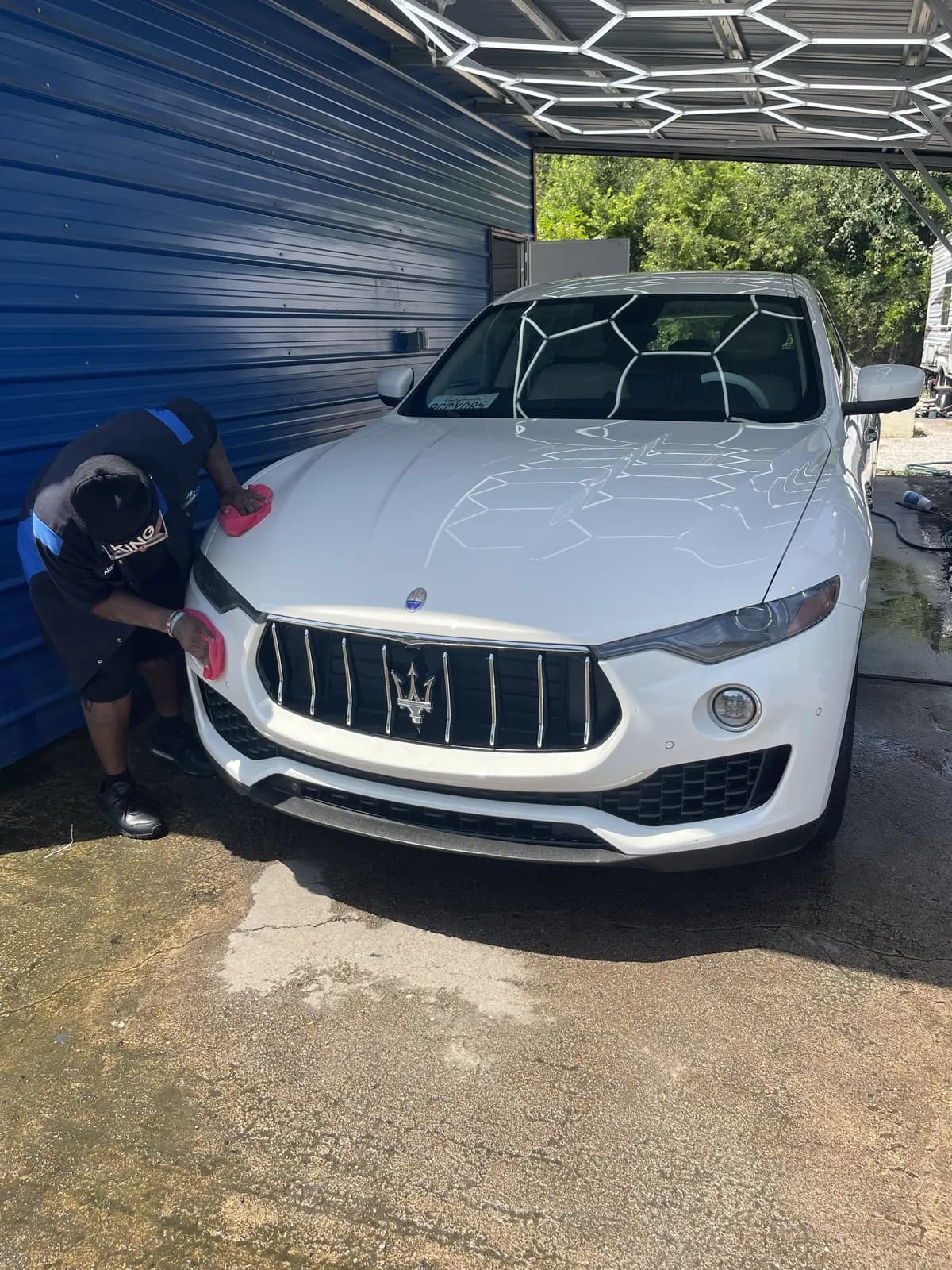 White Maserati Levante being polished