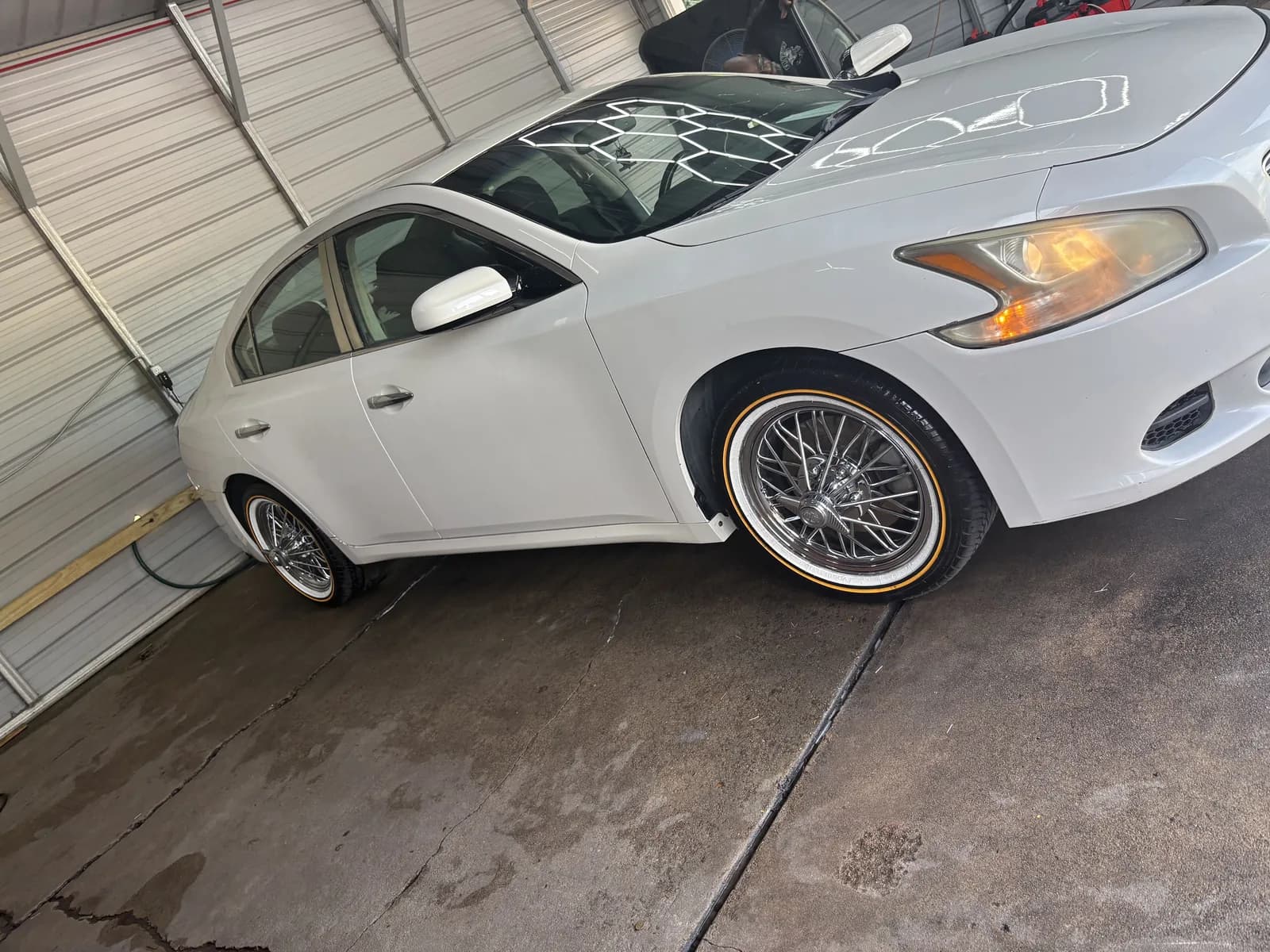 White sedan on Vogue tires cleaned up in the bay